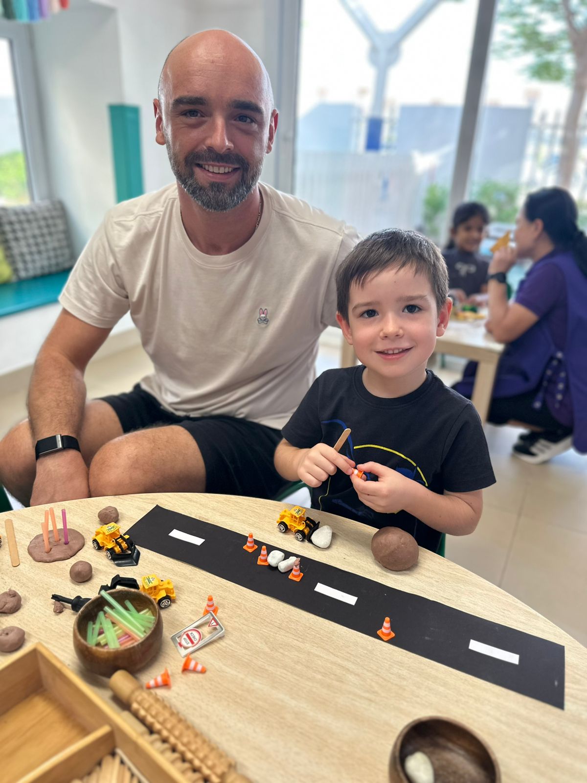 best british curriculum nursery dubai sports city Father and son enjoying a bonding activity at the best British curriculum nursery in Dubai Sports City