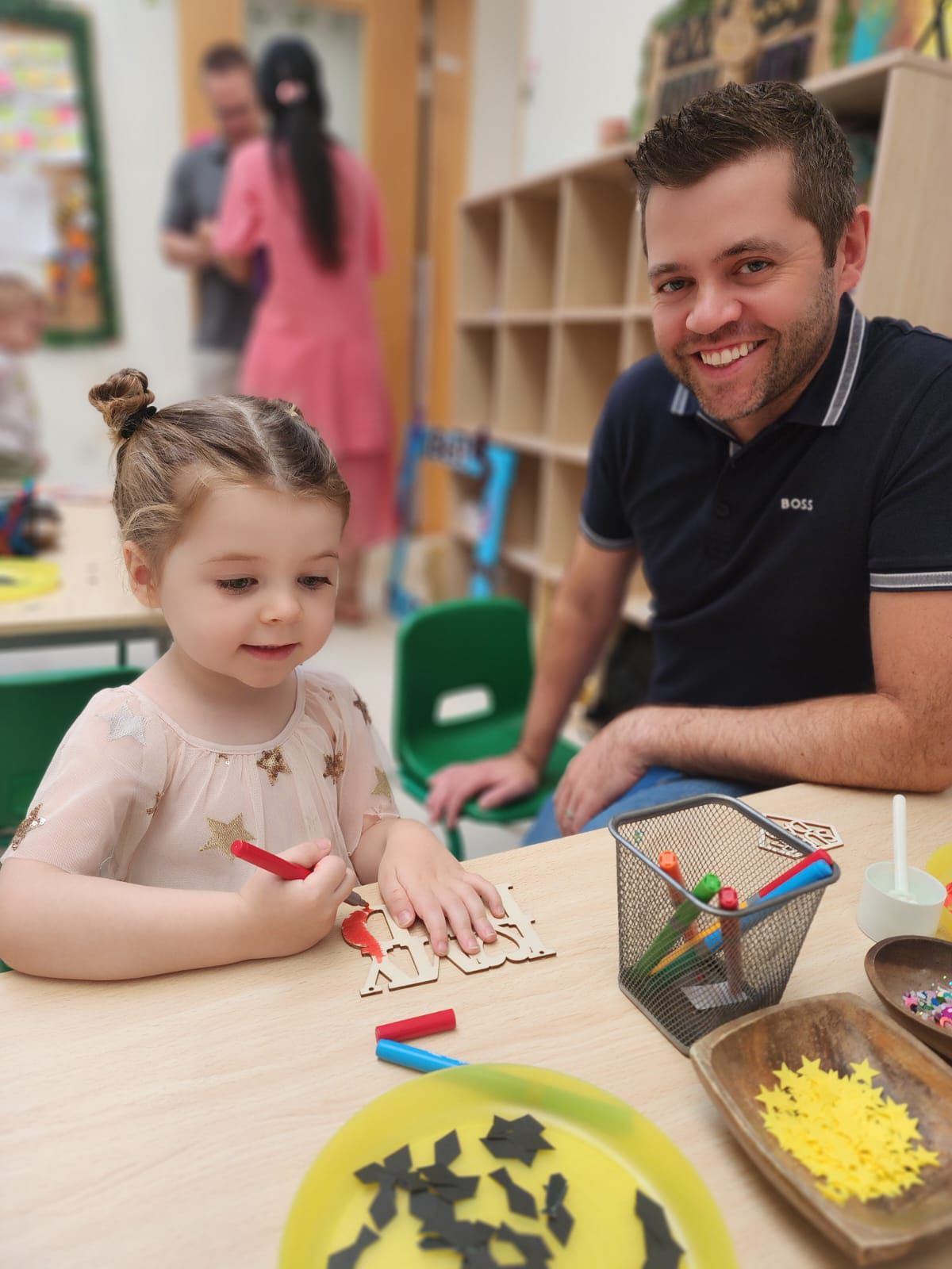 best british nursery in dubai Child creating a Father’s Day craft with her dad at the best British nursery in Dubai