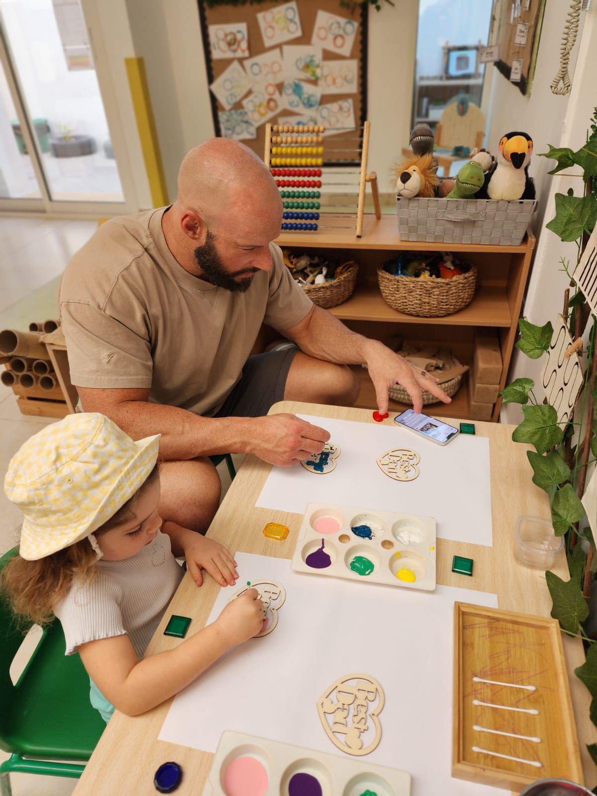 nursery school near me dubai Father and daughter painting together at a top nursery school in Dubai