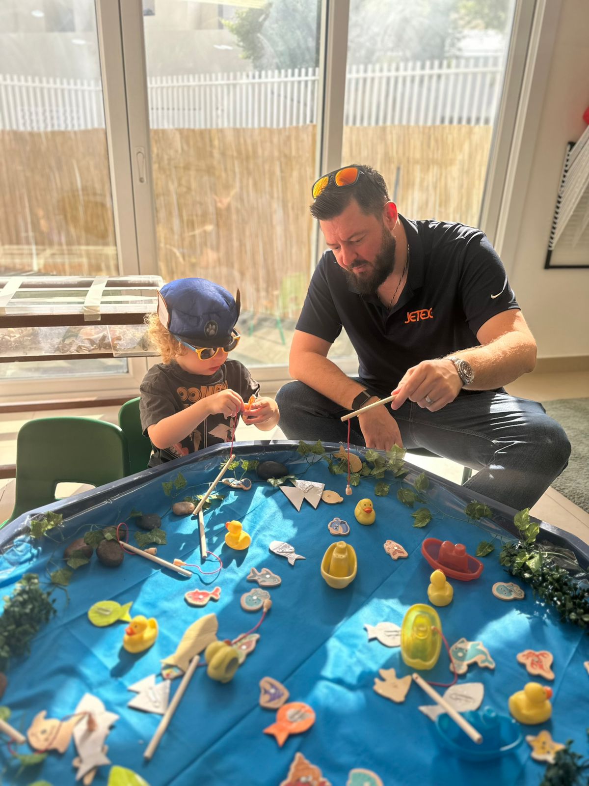 nursery school Father and child enjoying water play during Father’s Day activity at a nursery school in Dubai