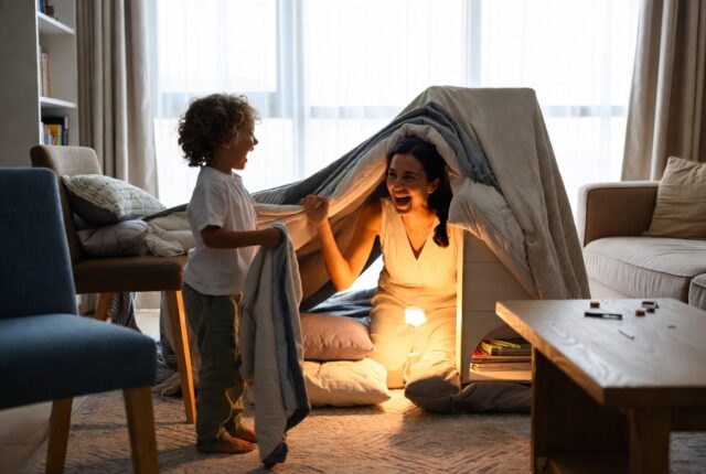 Mother and child building a cozy den for EYFS imaginative play at home in Dubai
